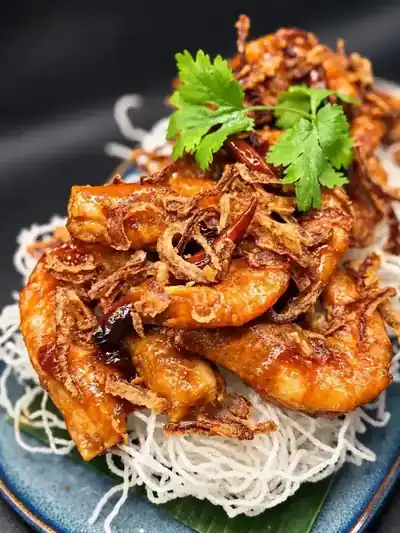 Thai Haven chicken finished with crispy shallots and herbs